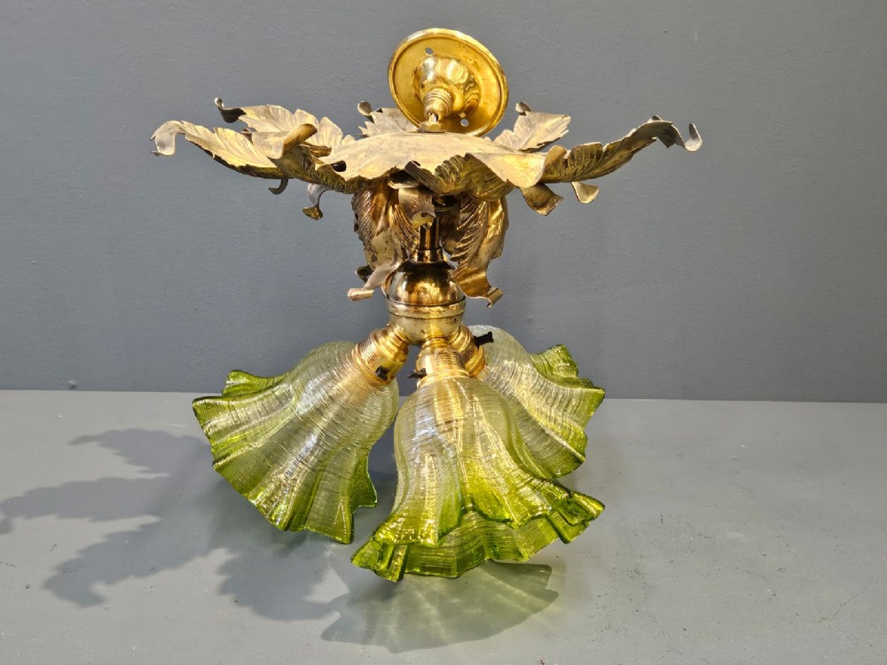 Victorian ceiling light featuring cast brass leaf motifs around the ceiling mount above fluted green glass shades. View VII