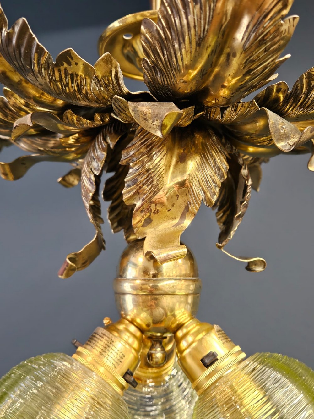 Victorian ceiling light featuring cast brass leaf motifs around the ceiling mount above fluted green glass shades. View VIII