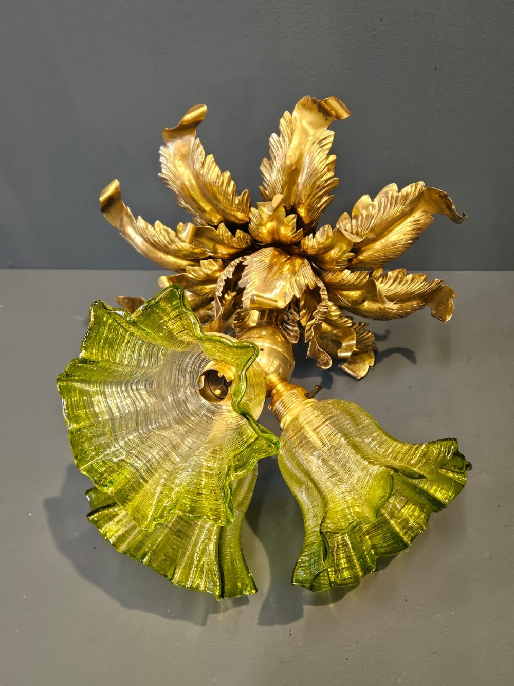 Victorian ceiling light featuring cast brass leaf motifs around the ceiling mount above fluted green glass shades. View X