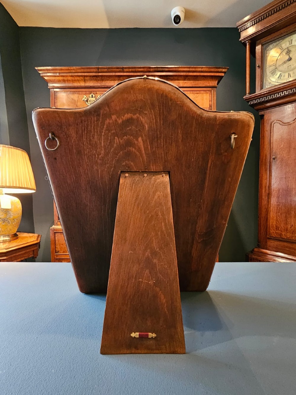 A Victorian easel-back mirror featuring an embossed silver frame decorated with scrollwork, acanthus leaves, and a central cresting cartouche around a bevelled glass plate. View III