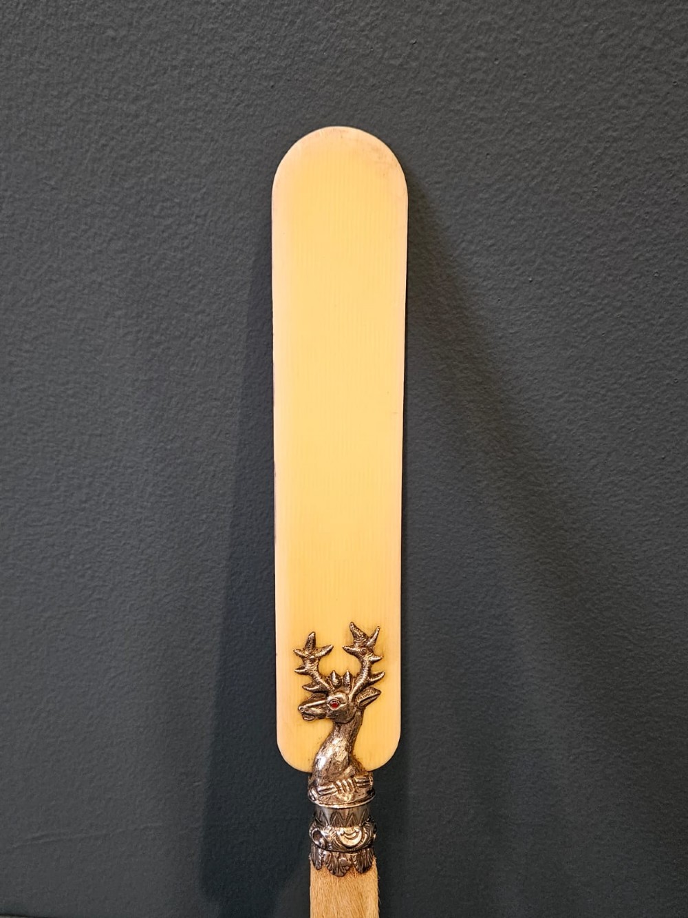 A Victorian page turner with a smooth cream blade, a silver deer motif at the base, and a taxidermy deer hoof handle. View IV