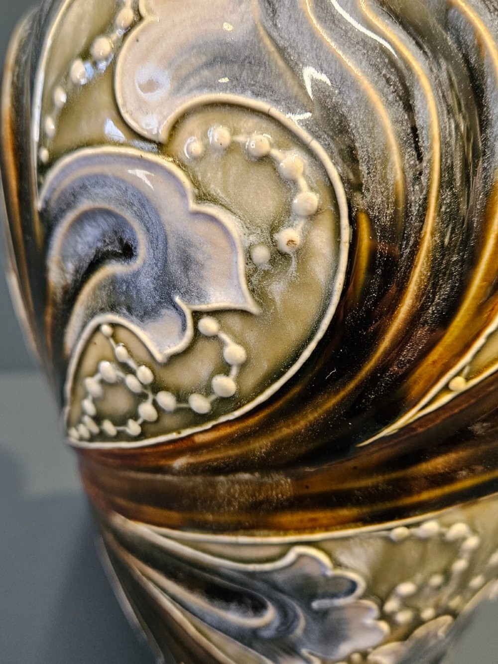 A tall Victorian Doulton Lambeth stoneware ewer decorated with incised leaf motifs, white beaded slipwork, an ochre handle, and a deep cobalt blue glazed interior. View II