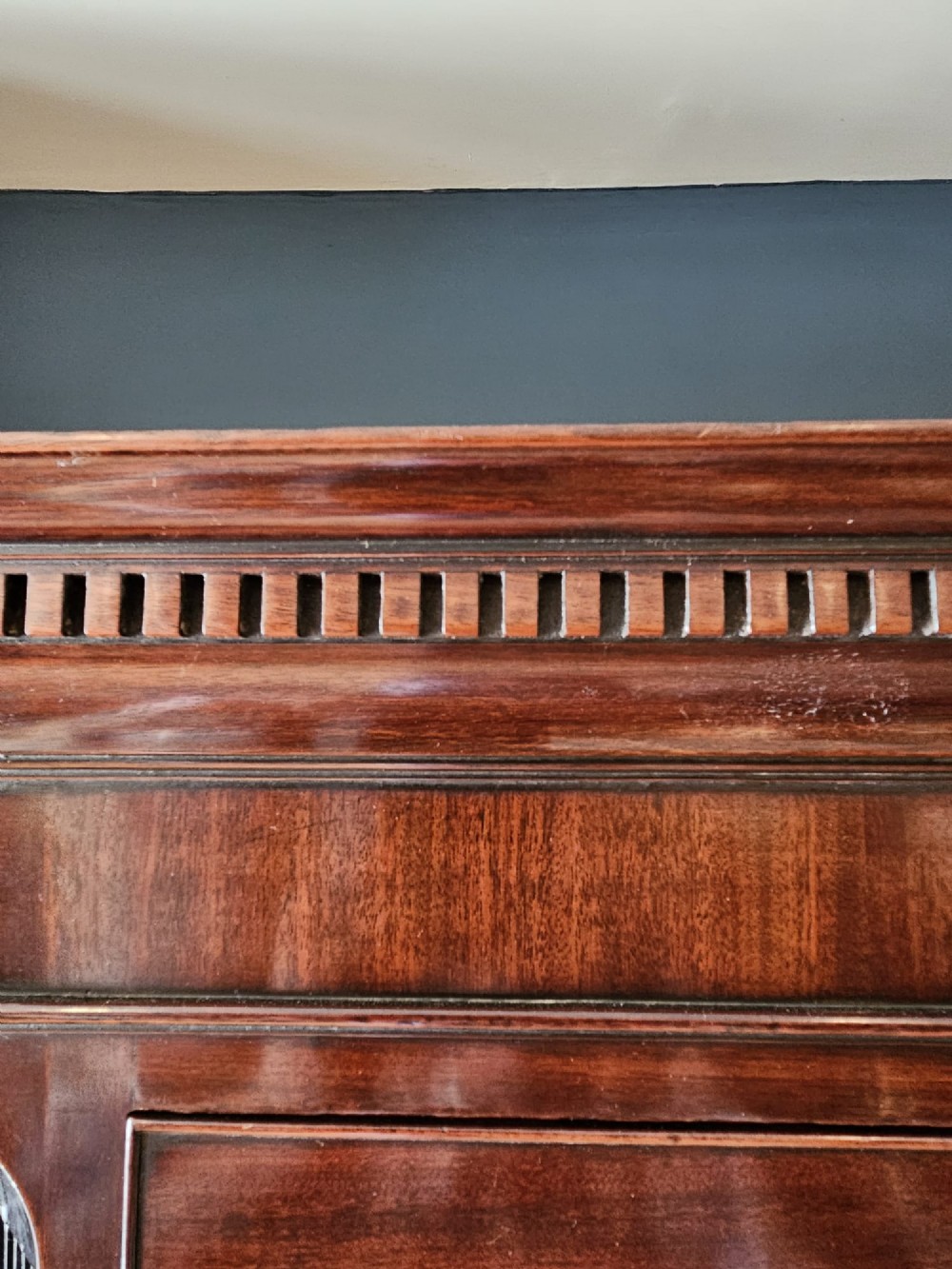 A George III mahogany chest on chest featuring two stacked drawer sections, swan-neck brass handles, dentil moulding, and bracket feet. View V