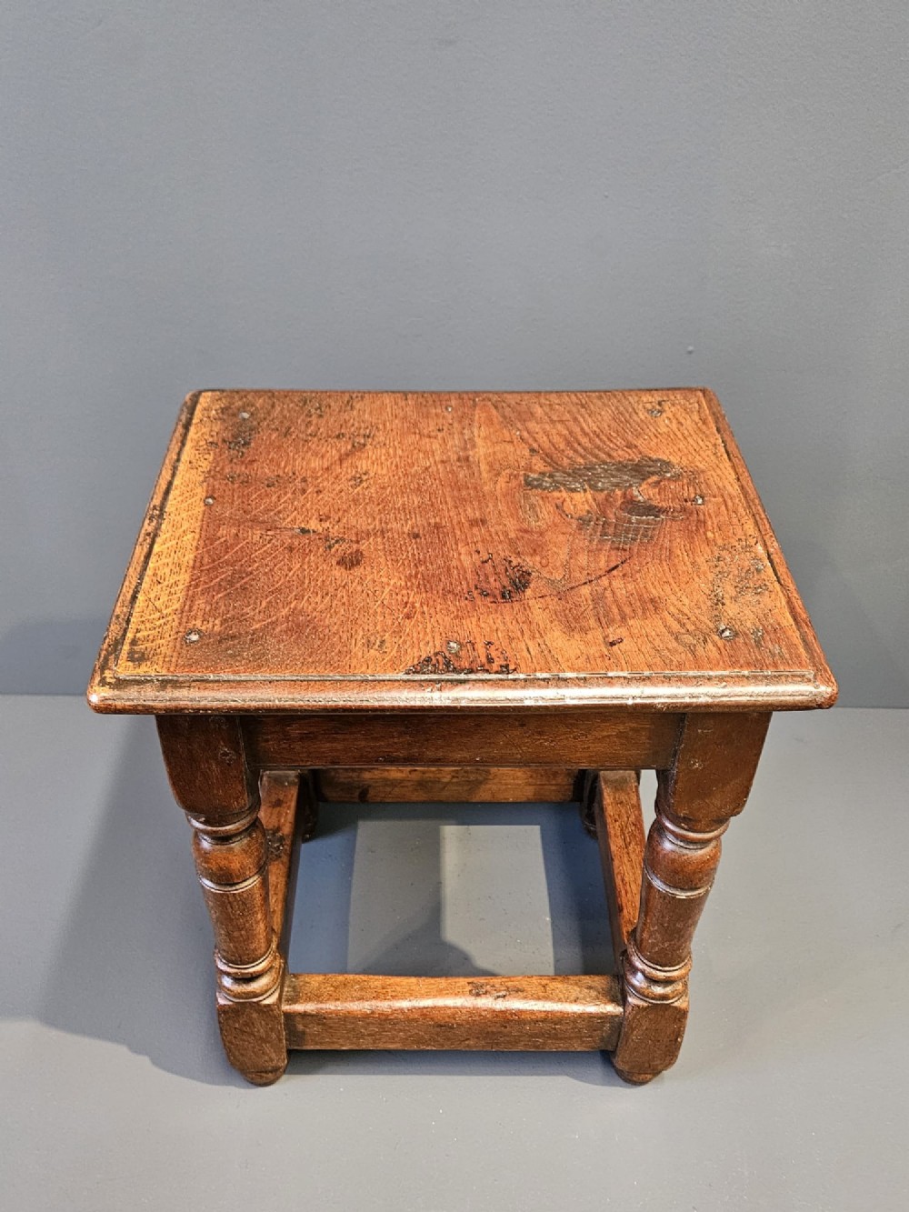 A George III oak joint stool featuring turned legs, lower stretchers, and a moulded rectangular top. View IV