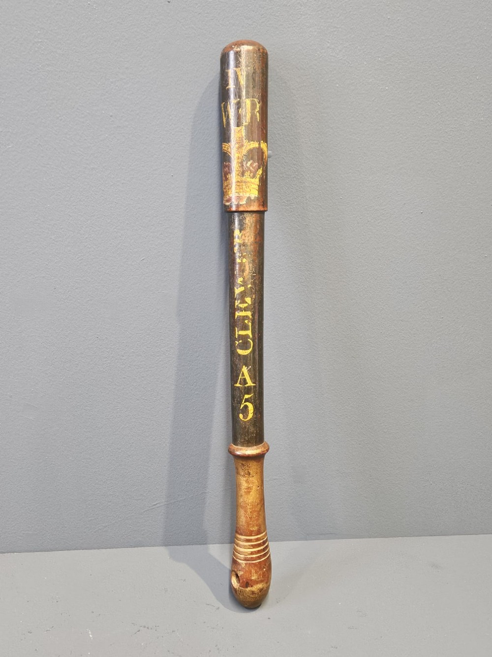 A turned dark hardwood police truncheon with hand-painted WR IV royal insignia, a crown, parish lettering reading CLEAVER A5, and a ribbed handle with a wrist strap hole.