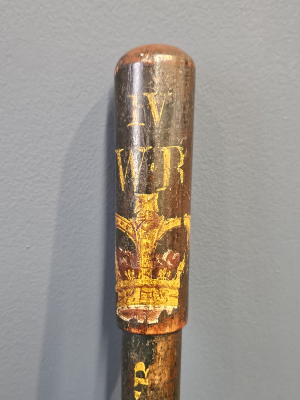 A turned dark hardwood police truncheon with hand-painted WR IV royal insignia, a crown, parish lettering reading CLEAVER A5, and a ribbed handle with a wrist strap hole. View III