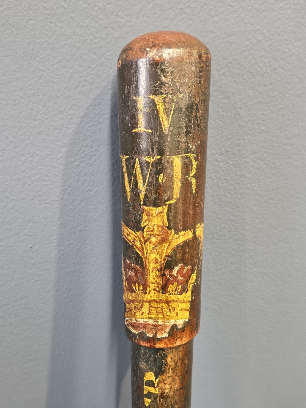 A turned dark hardwood police truncheon with hand-painted WR IV royal insignia, a crown, parish lettering reading CLEAVER A5, and a ribbed handle with a wrist strap hole. View IV