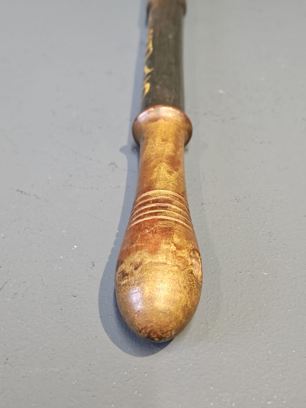 A turned dark hardwood police truncheon with hand-painted WR IV royal insignia, a crown, parish lettering reading CLEAVER A5, and a ribbed handle with a wrist strap hole. View VII