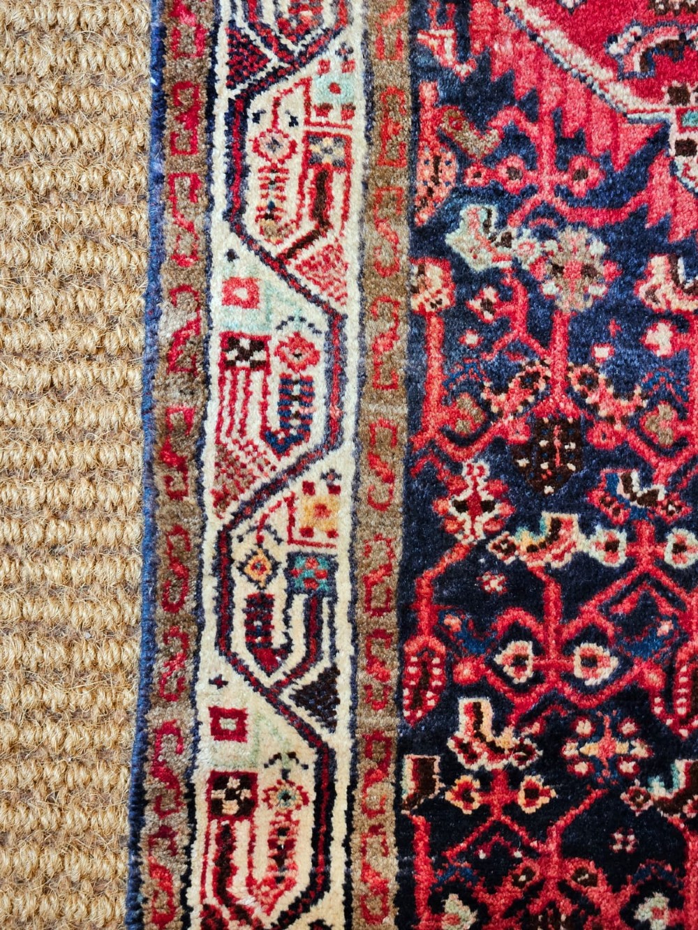 A long hand-knotted wool runner rug featuring deep navy blue and terracotta geometric medallion patterns with a cream decorated border. View II