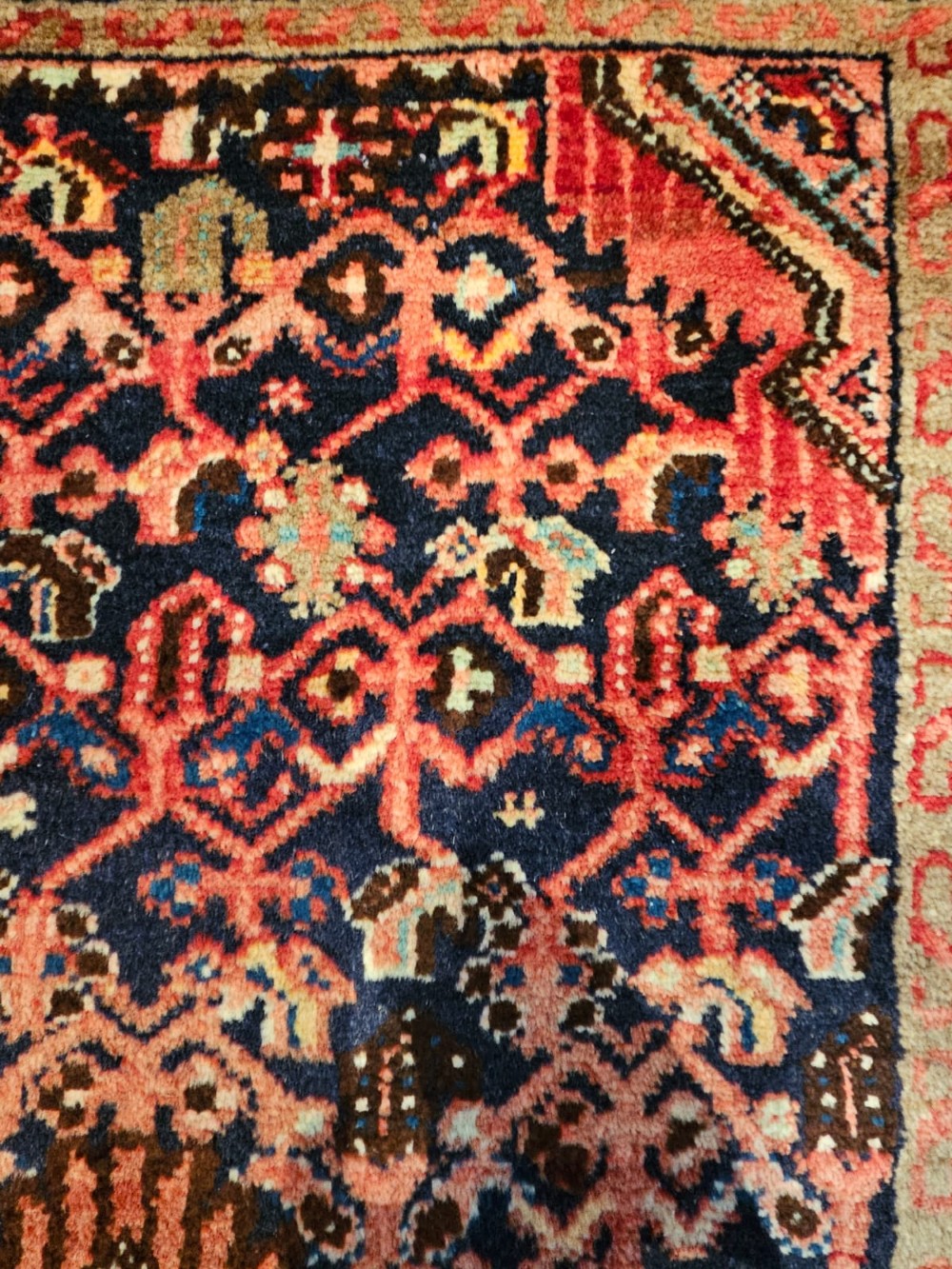 A long hand-knotted wool runner rug featuring deep navy blue and terracotta geometric medallion patterns with a cream decorated border. View VIII