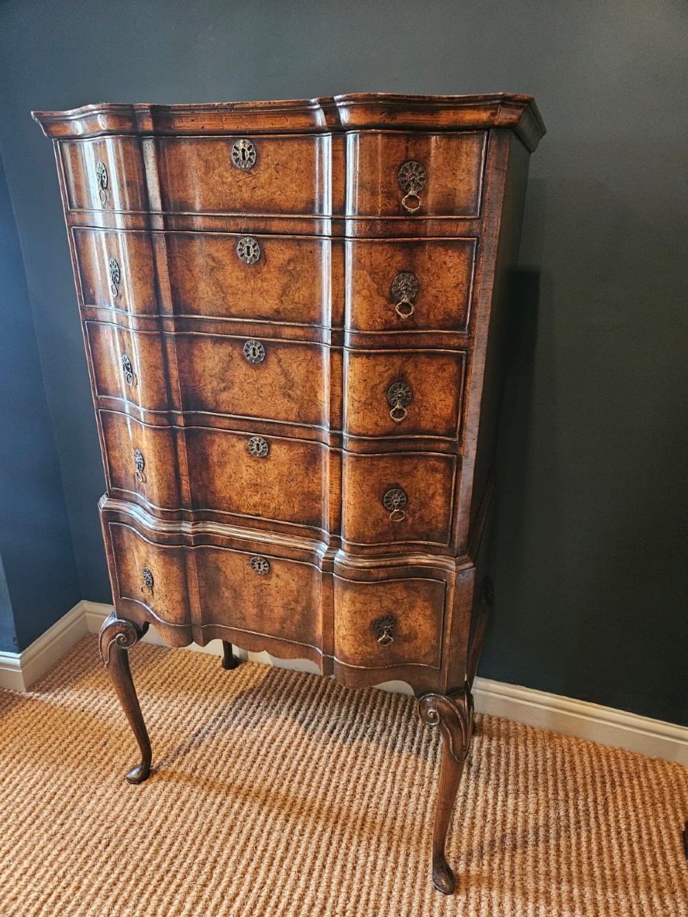 An Edwardian burr walnut chest on stand featuring a serpentine front, ornate brass handles, and slender cabriole legs. View III