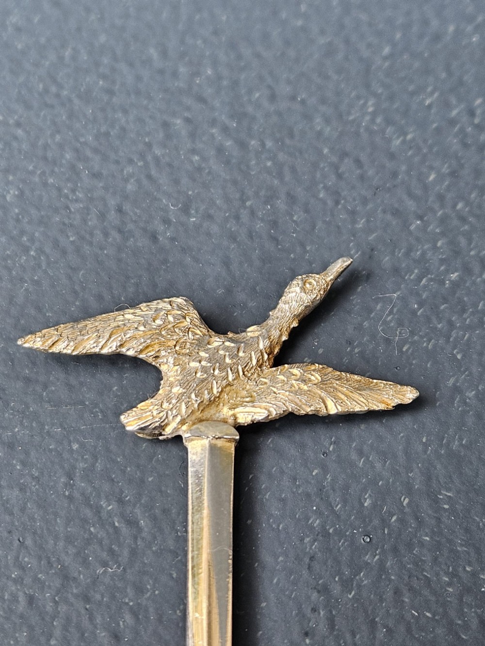 A set of six silver cocktail sticks featuring cast animal finials, arranged inside a fitted presentation box with cream silk and dark velvet lining. View IV