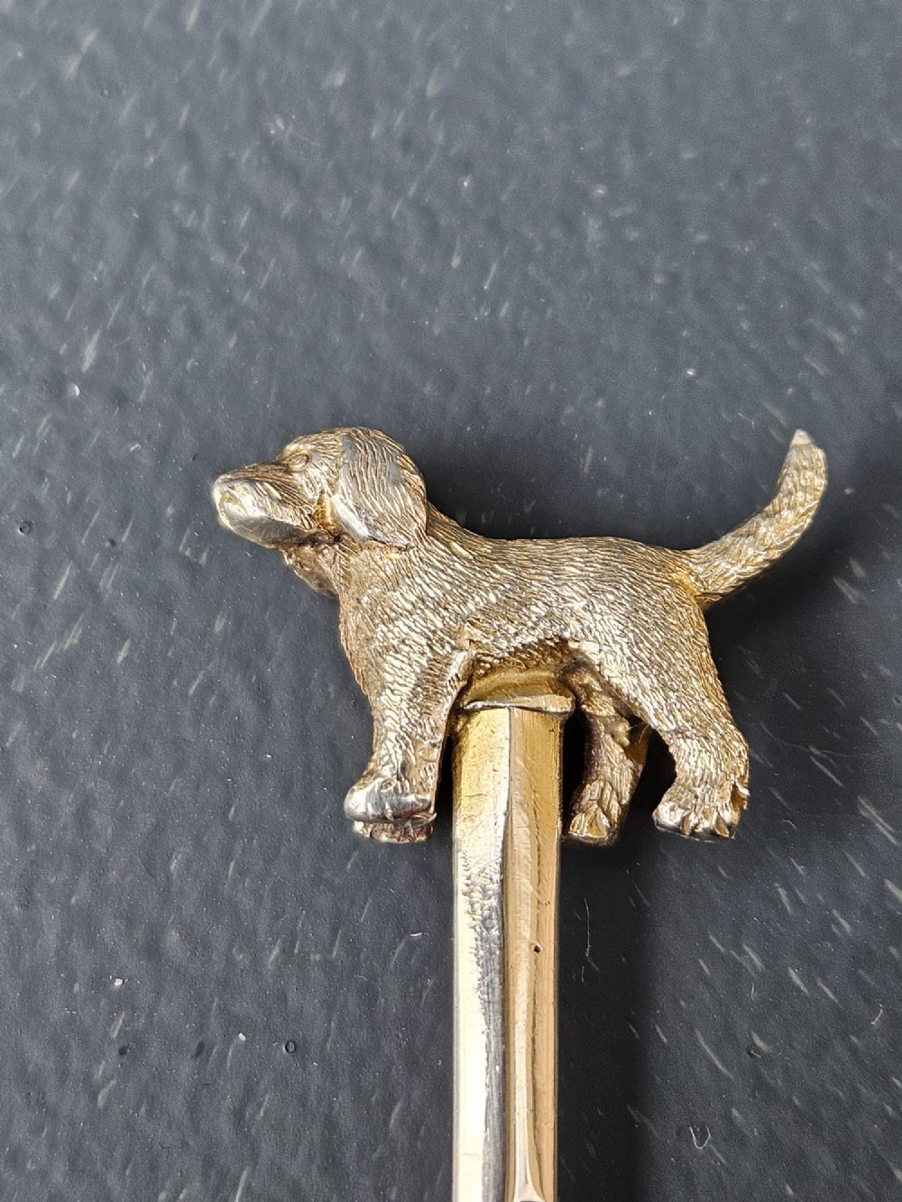 A set of six silver cocktail sticks featuring cast animal finials, arranged inside a fitted presentation box with cream silk and dark velvet lining. View V