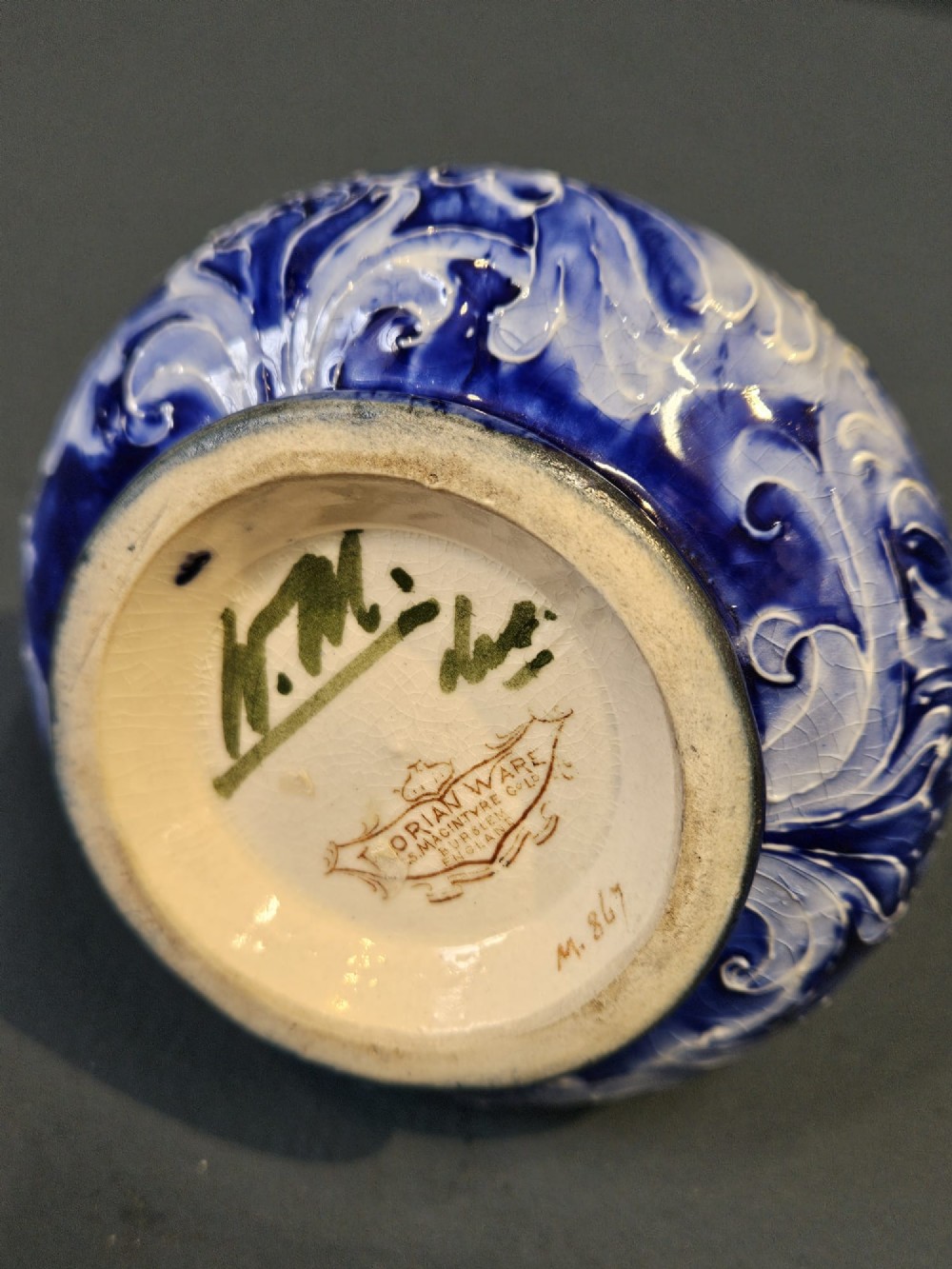 An Art Nouveau ceramic vase featuring a bulbous base, slender elongated neck, and cobalt blue tube-lined cornflower motif on a pale ground. View V