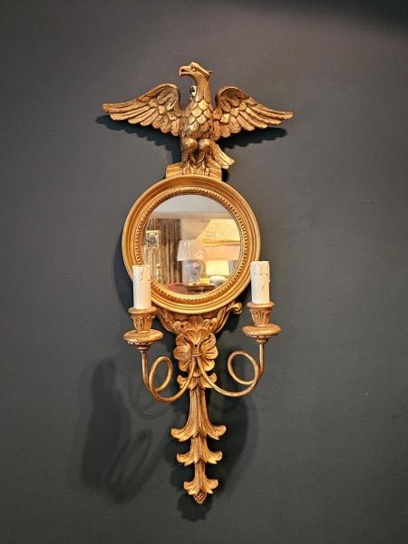 A pair of gold gilt wall sconces featuring eagle tops, circular convex mirrors, and twin candle arms. View II