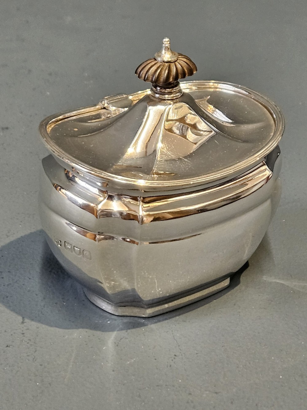 A shaped Victorian silver tea caddy featuring a lobed body, a stepped cover, and a gadrooned finial. View III