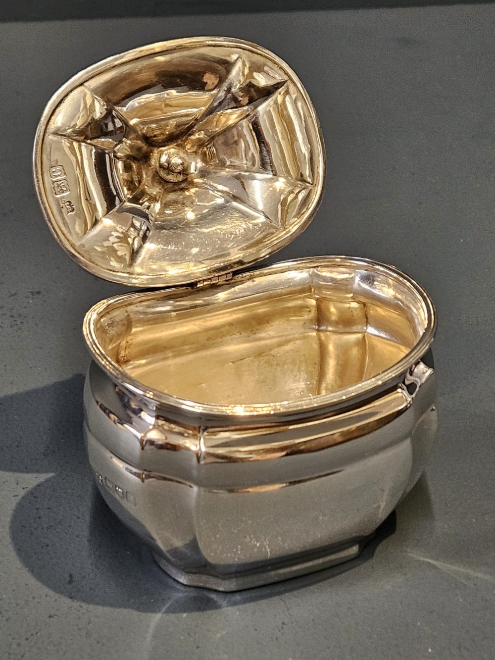 A shaped Victorian silver tea caddy featuring a lobed body, a stepped cover, and a gadrooned finial. View IV
