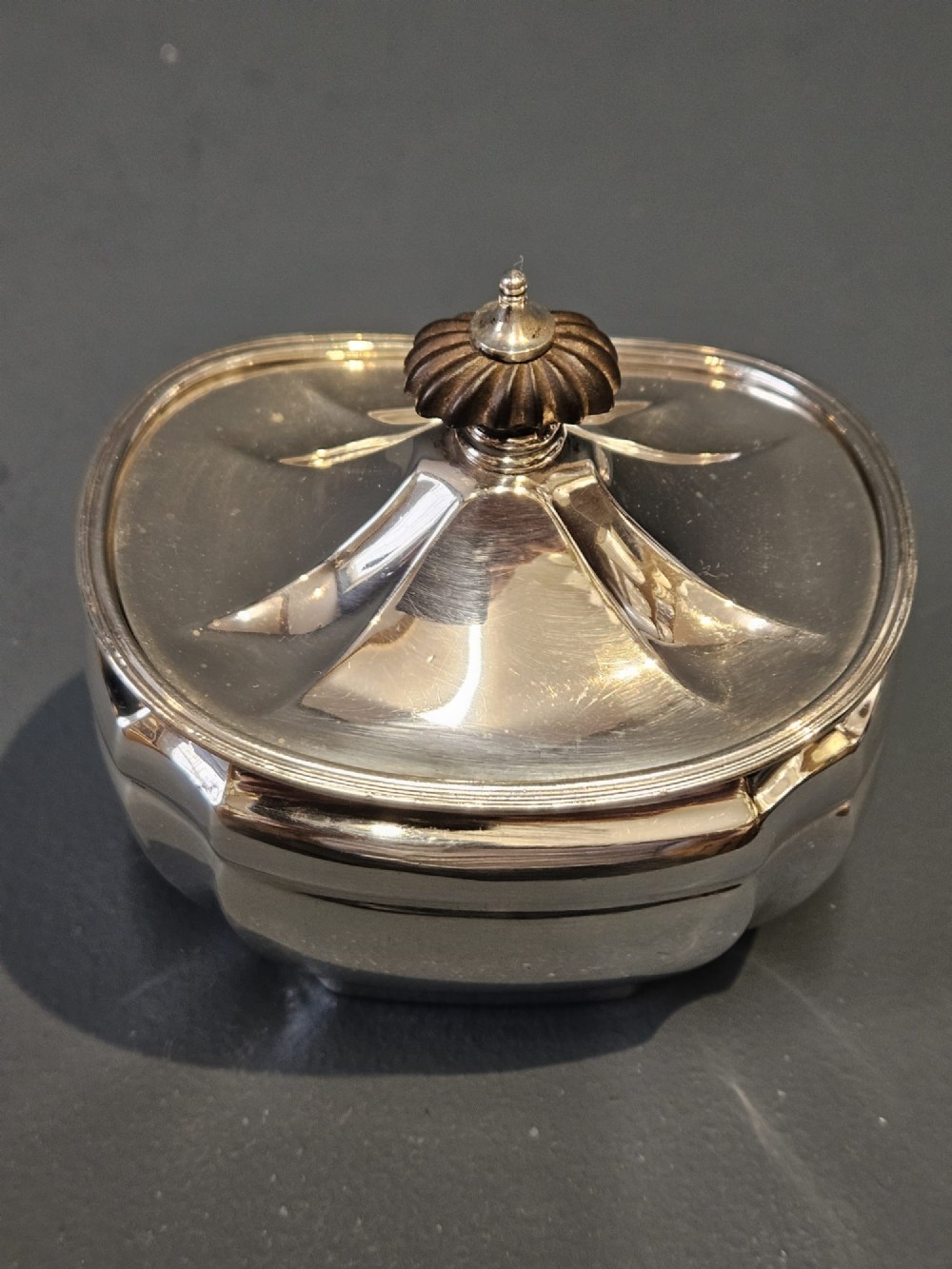 A shaped Victorian silver tea caddy featuring a lobed body, a stepped cover, and a gadrooned finial. View VIII