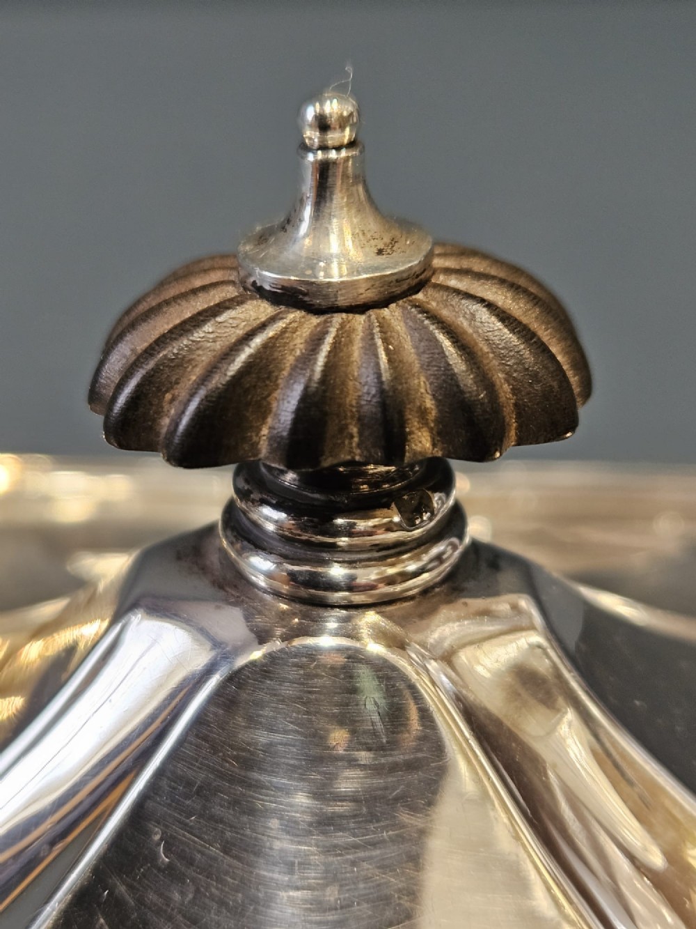A shaped Victorian silver tea caddy featuring a lobed body, a stepped cover, and a gadrooned finial. View IX