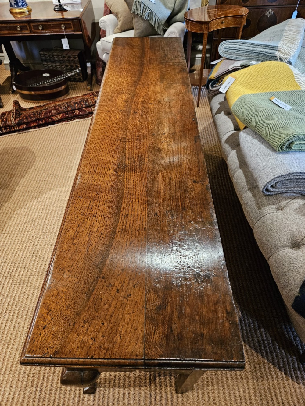 A George II oak dresser base featuring three drawers, brass handles, a shaped apron, and four cabriole legs. View IV