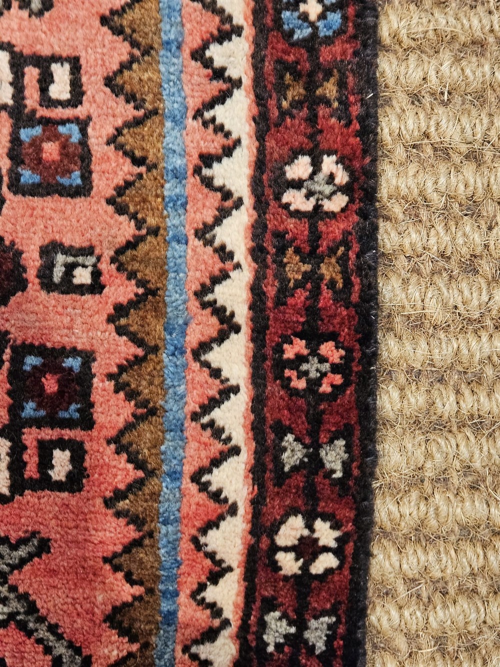 A long hand-knotted pure wool runner rug featuring geometric medallions in rose pink, navy blue, and cream. View IV
