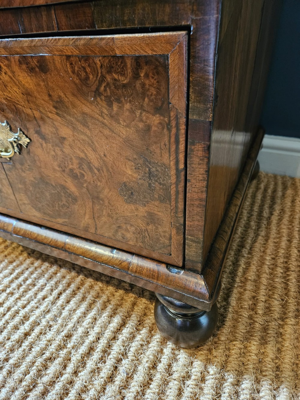 A George I burr walnut chest on chest featuring multiple stacked drawers with brass escutcheons and a dished sunburst motif on the lower drawer. View III
