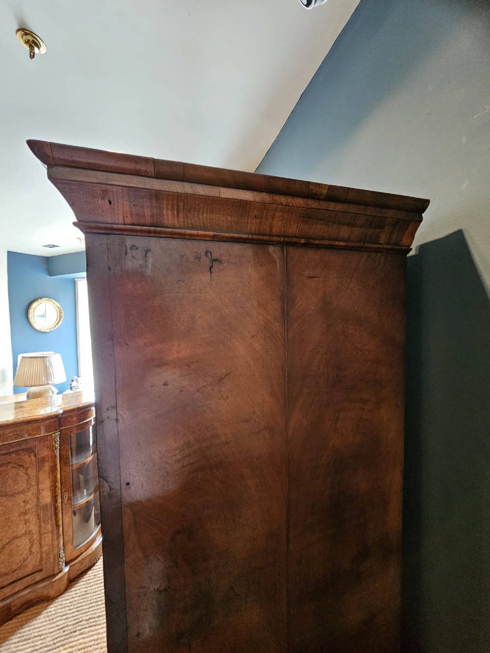 A George I burr walnut chest on chest featuring multiple stacked drawers with brass escutcheons and a dished sunburst motif on the lower drawer. View VIII