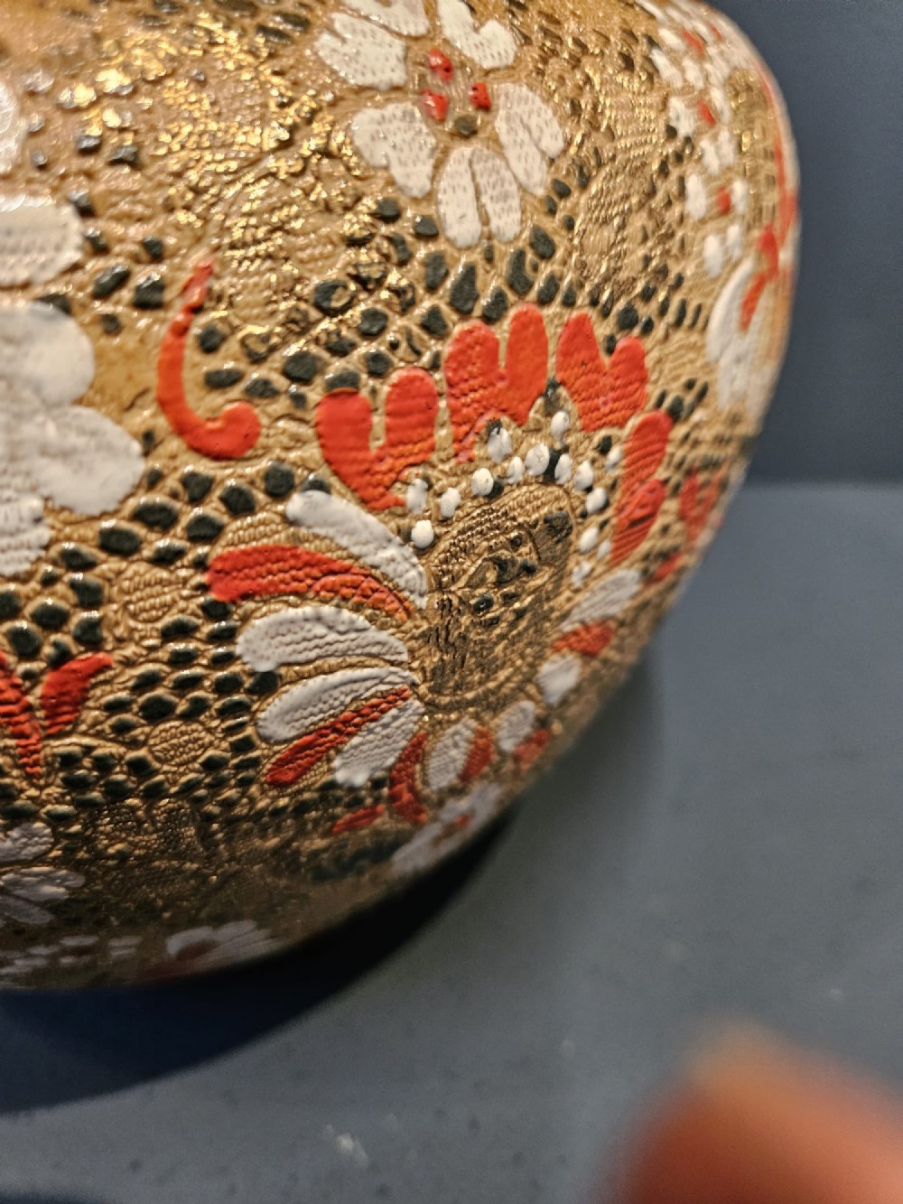 A Victorian Doulton Lambeth stoneware jardiniere featuring a wavy crimped rim, textured lace-impressed floral pattern in white and terracotta red on an ochre ground, and a dark brown upper band. View IV