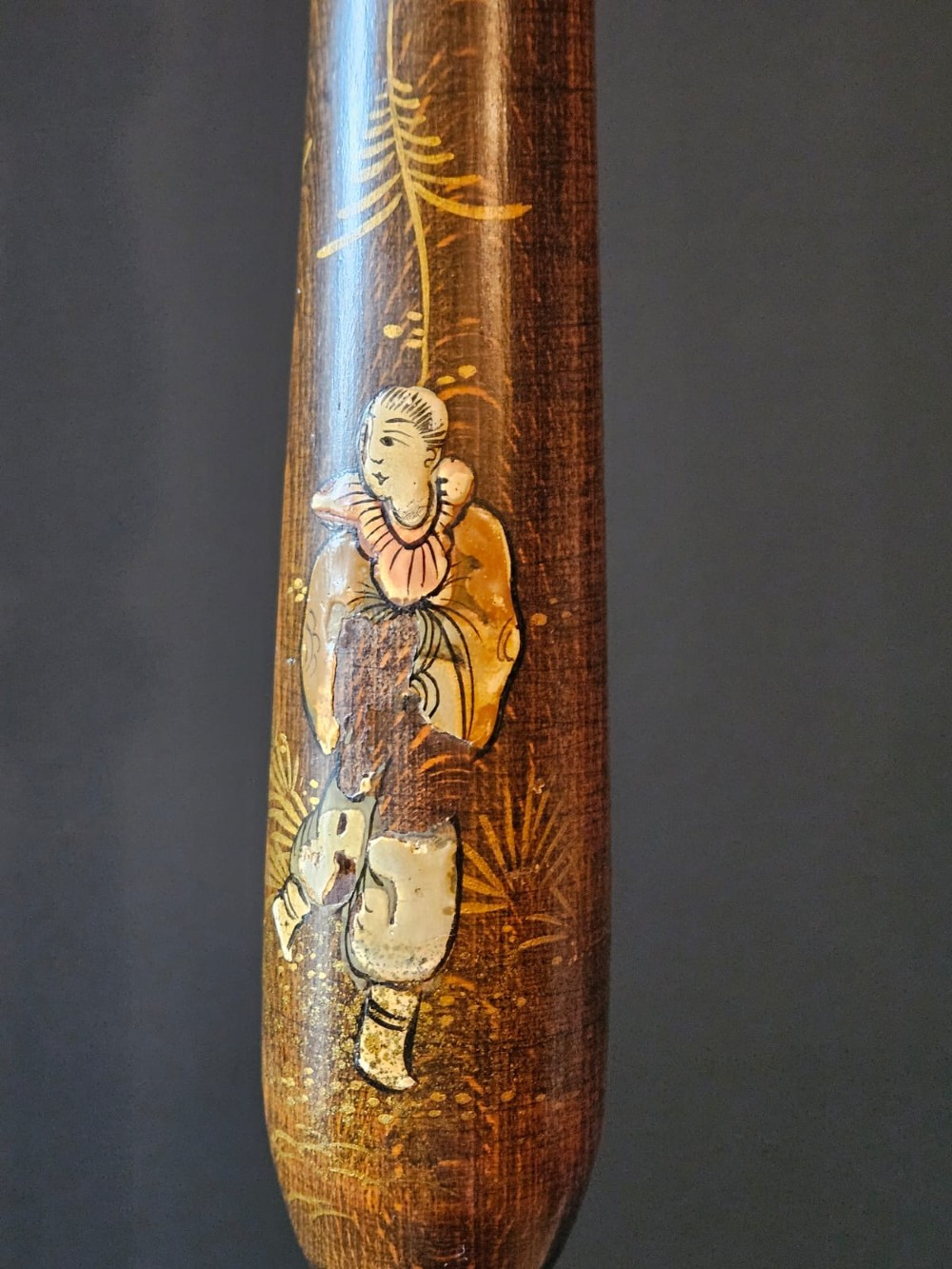 A turned 1920s Chinoiserie standard lamp made from dark lacquered wood decorated with gold painted oriental figures and motifs on a circular base. View II
