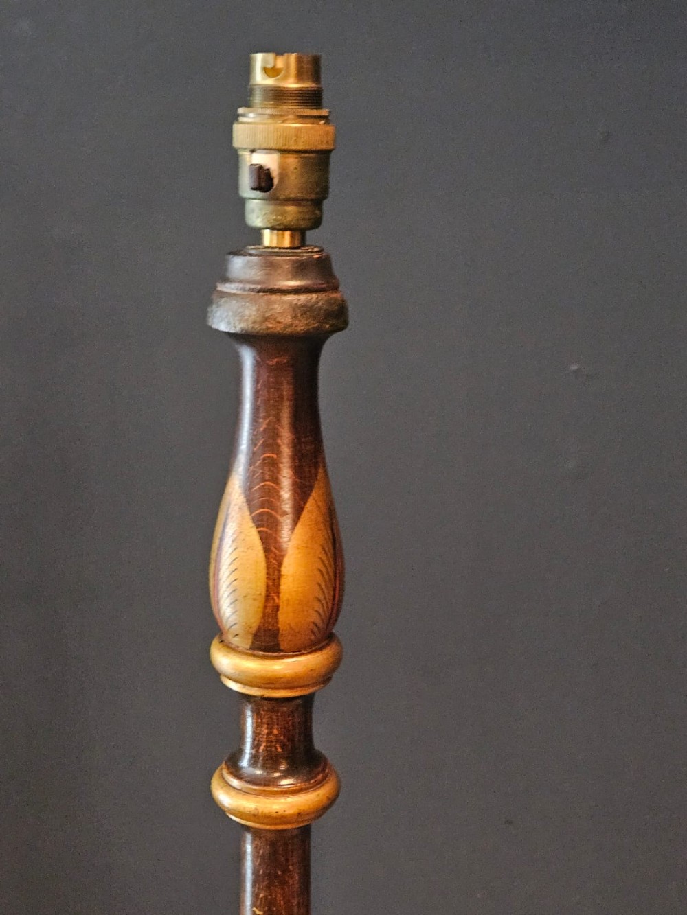 A turned 1920s Chinoiserie standard lamp made from dark lacquered wood decorated with gold painted oriental figures and motifs on a circular base. View III