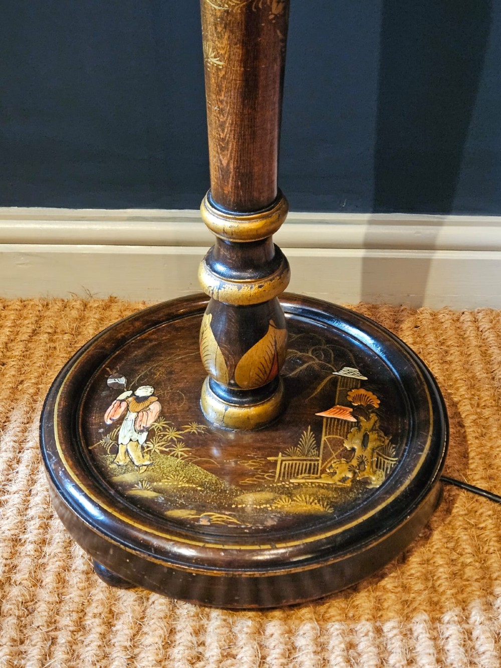 A turned 1920s Chinoiserie standard lamp made from dark lacquered wood decorated with gold painted oriental figures and motifs on a circular base. View IV