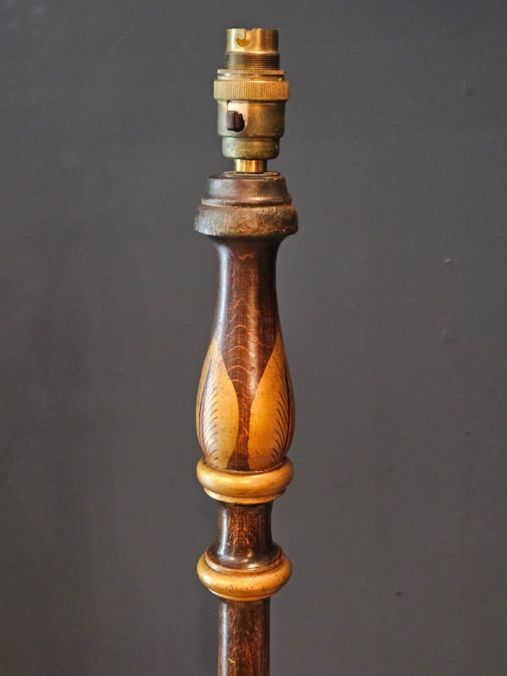 A turned 1920s Chinoiserie standard lamp made from dark lacquered wood decorated with gold painted oriental figures and motifs on a circular base. View V