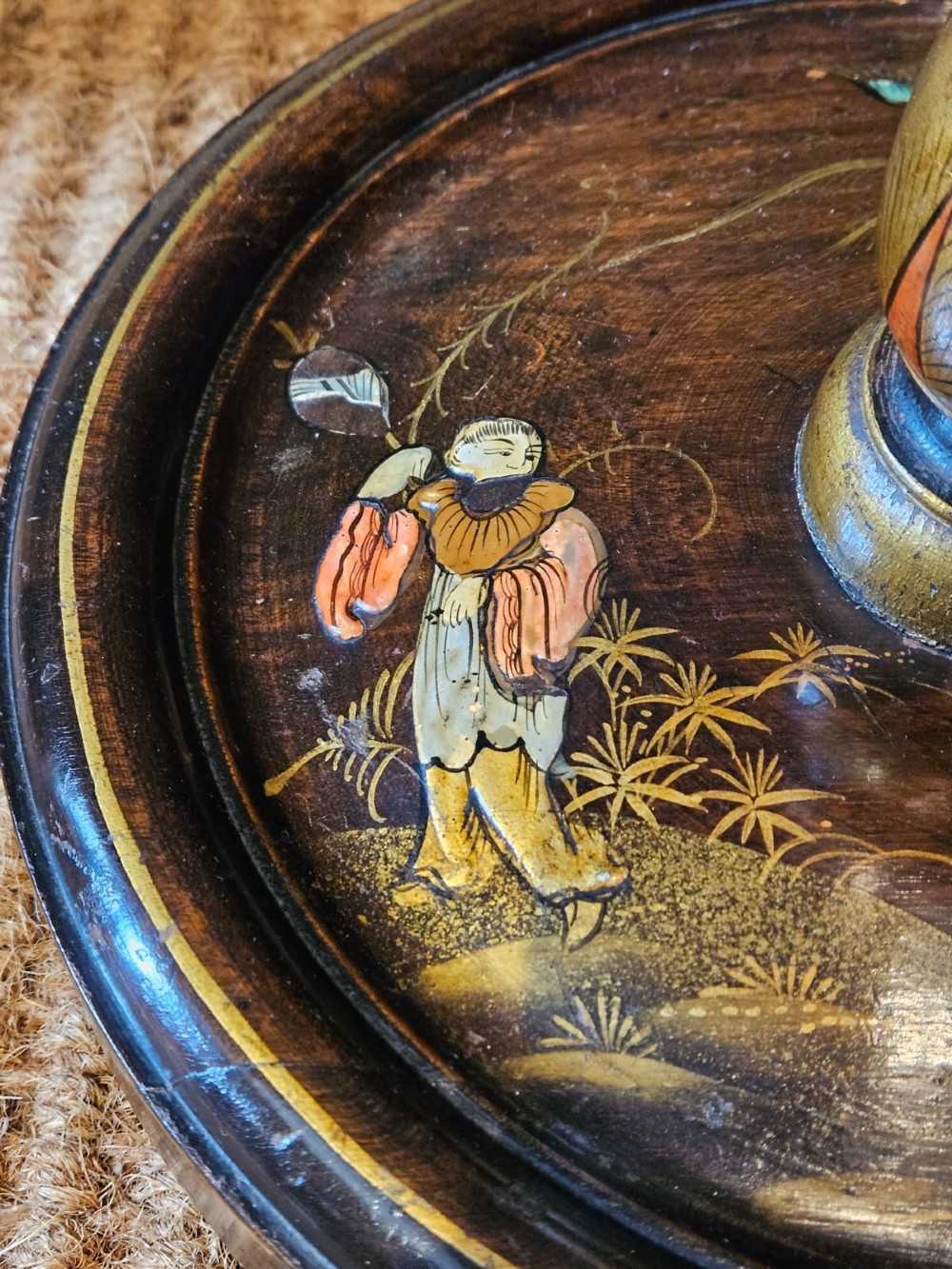 A turned 1920s Chinoiserie standard lamp made from dark lacquered wood decorated with gold painted oriental figures and motifs on a circular base. View VI