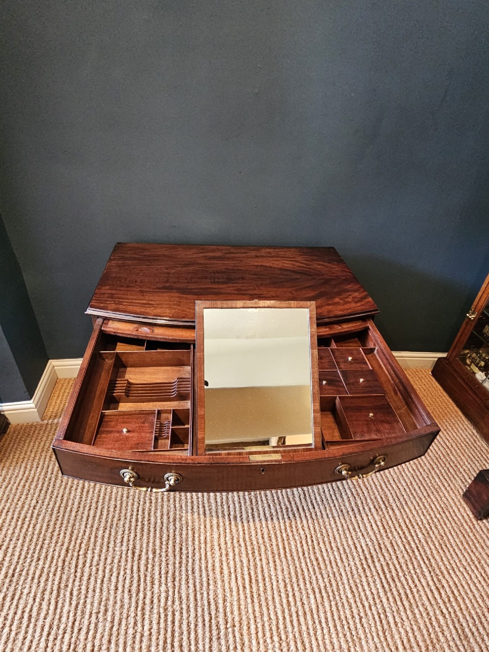 An 18th-century George III mahogany secretaire dressing chest featuring a kneehole configuration, multiple drawers with brass handles, and a central cupboard. View VII