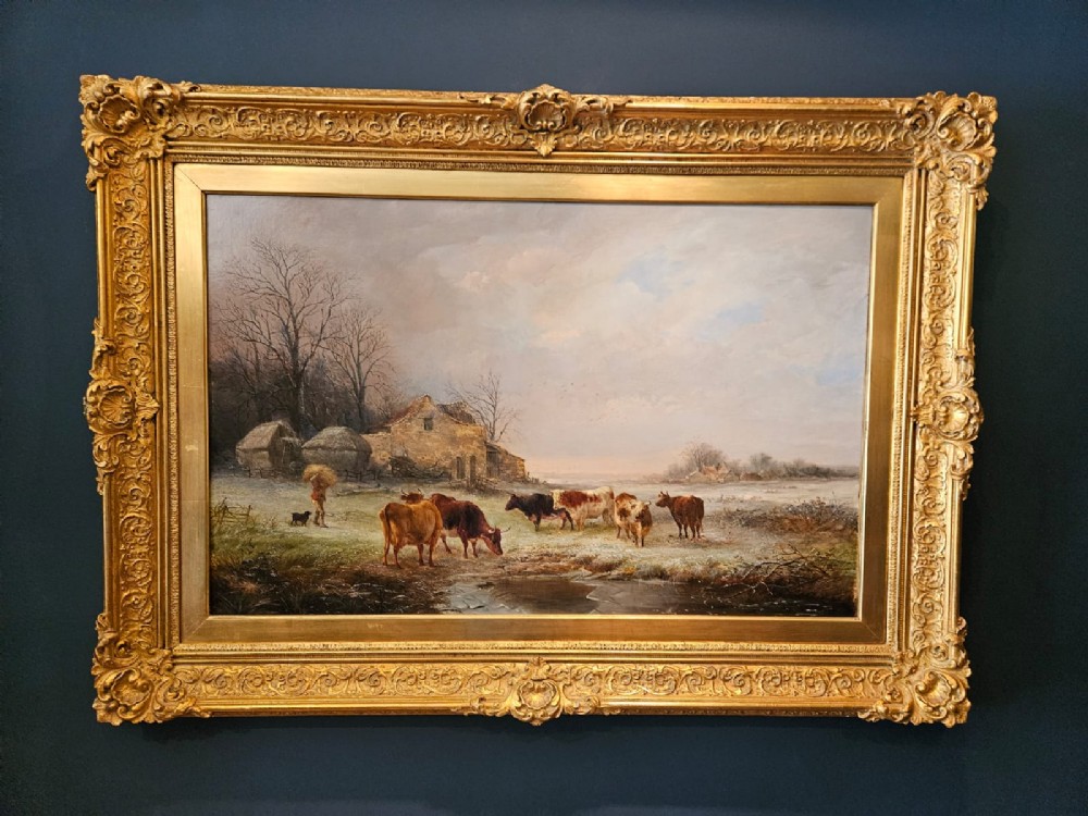 A 19th-century Victorian oil painting on canvas depicting a rural winter pastoral scene with cattle, set within an ornate gold gilt frame. View X