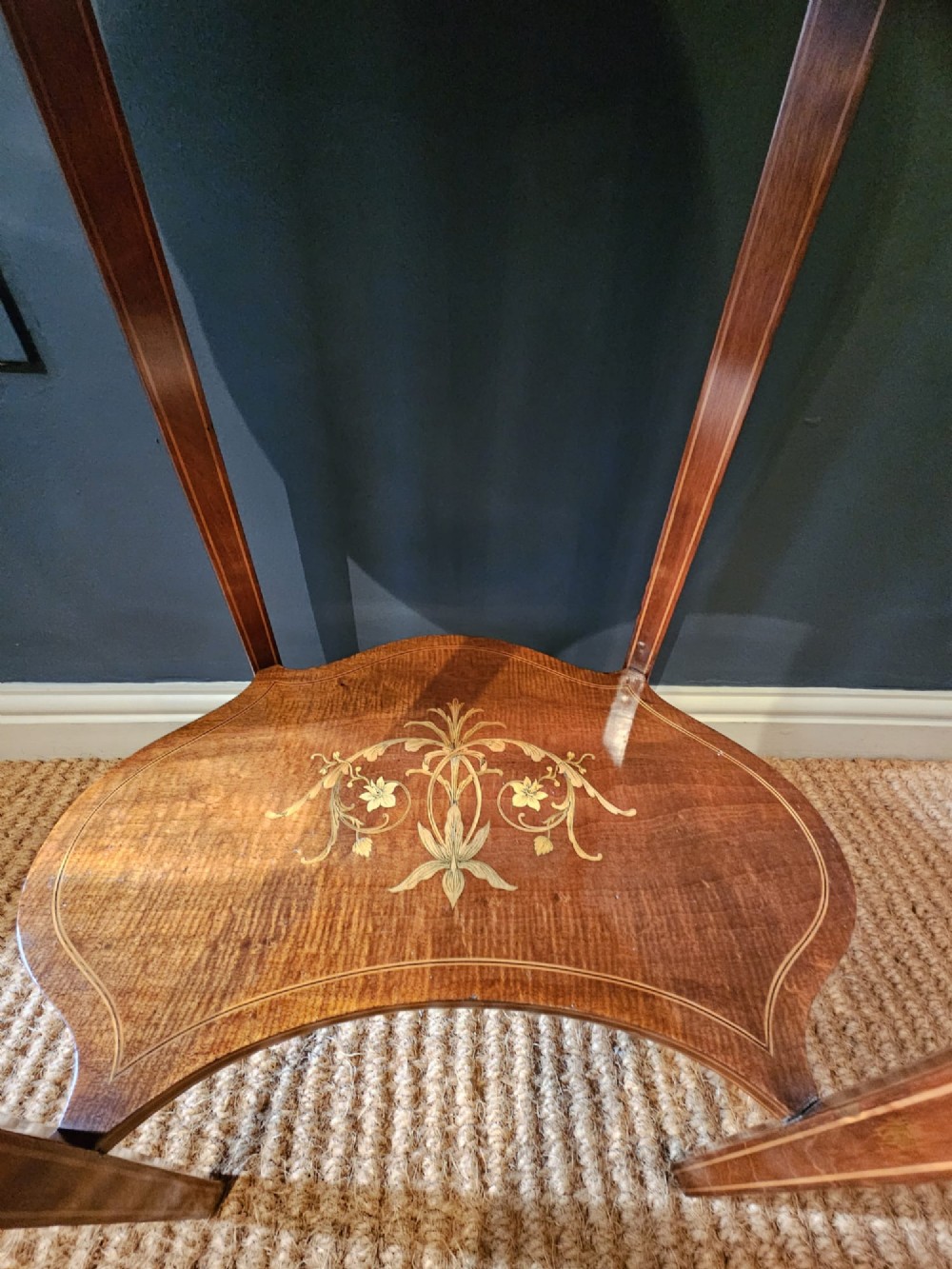 An Edwardian kidney-shaped mahogany occasional table featuring classical marquetry inlay, a single drawer, and an undertier shelf supported by slender tapered legs. View V