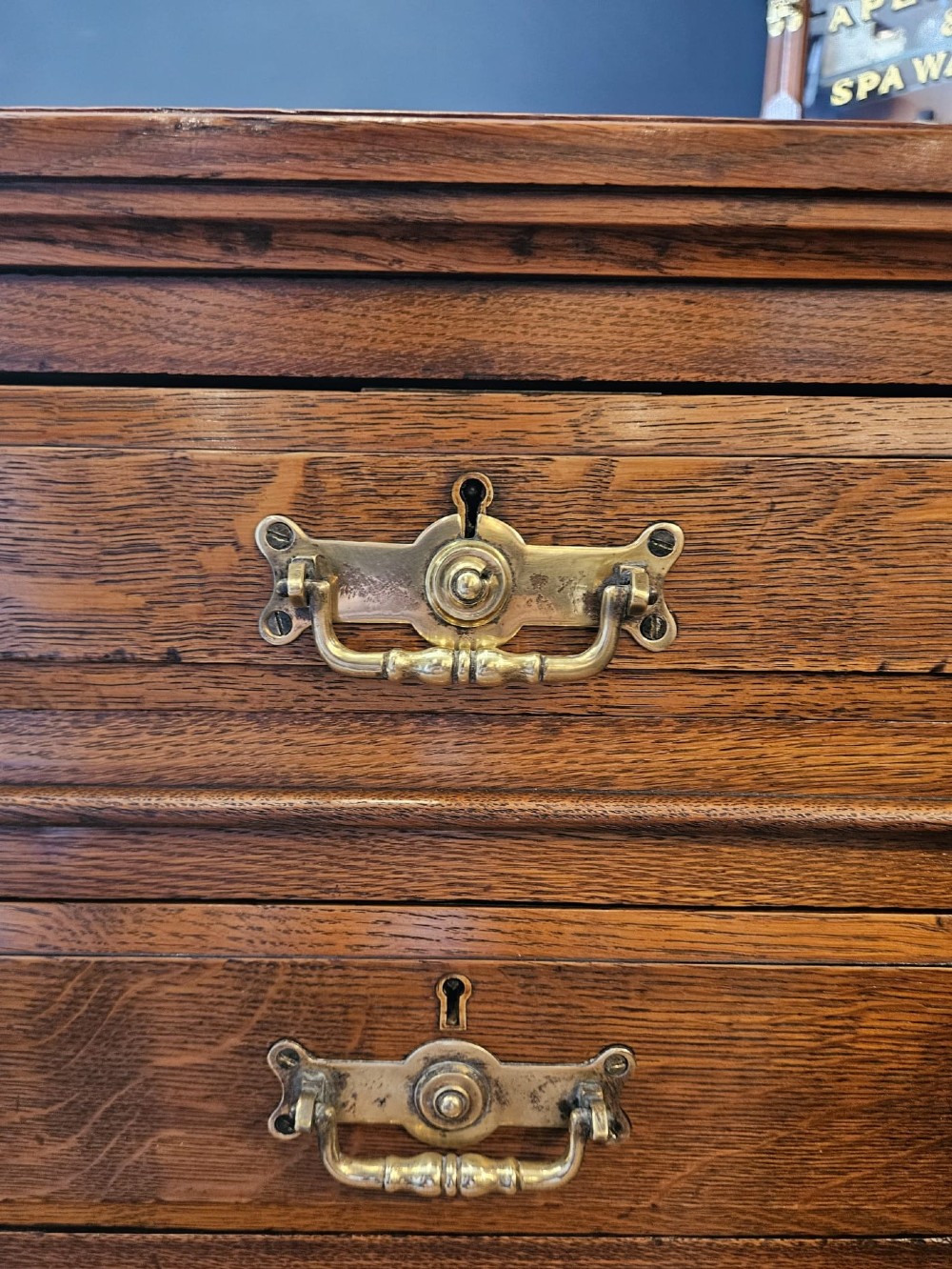 A Victorian oak pedestal desk featuring a red leather inset top, brass swing handles, and twin pedestals housing multiple drawers. View VIII
