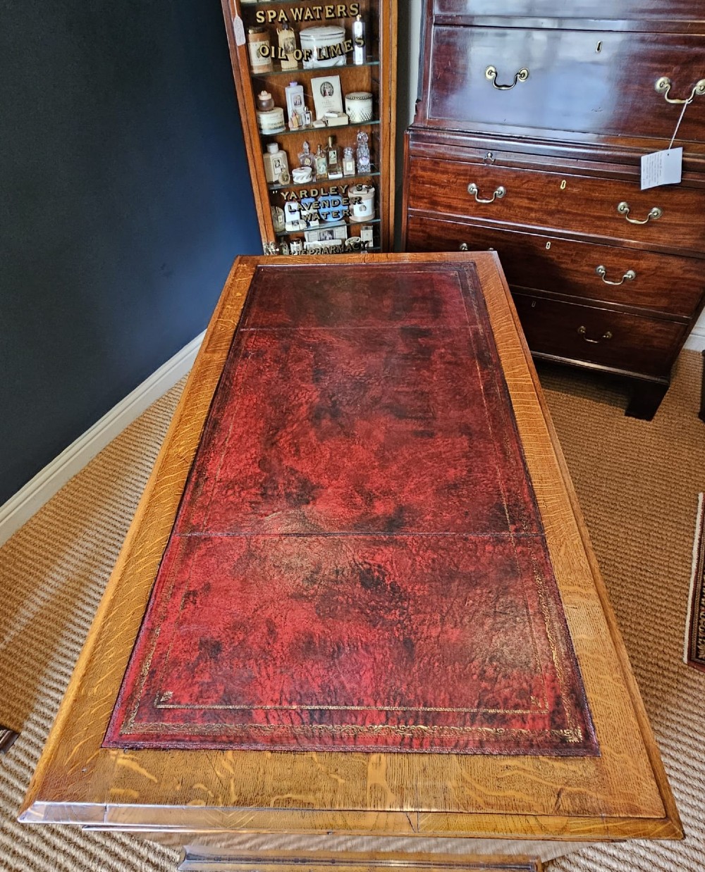 A Victorian oak pedestal desk featuring a red leather inset top, brass swing handles, and twin pedestals housing multiple drawers. View XI