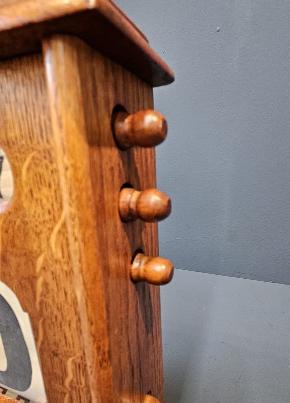 A late Victorian figured oak perpetual desk calendar with turned side knobs and three apertures displaying the day, date, and month. View VII