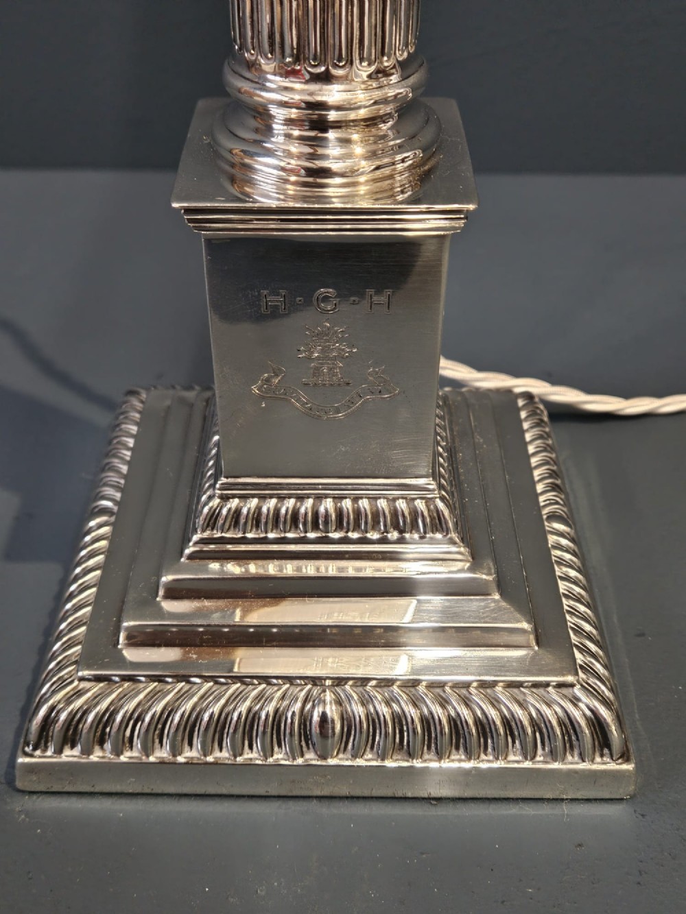 A Victorian silver Corinthian column table lamp with an acanthus leaf capital, fluted shaft, and engraved stepped base. View II