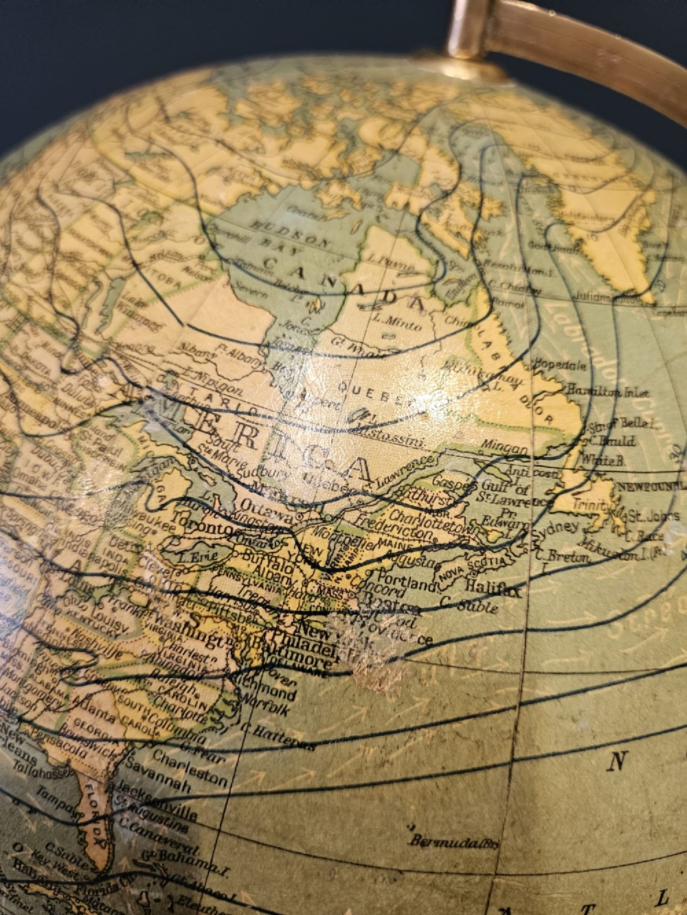 A 1920s terrestrial table globe with printed paper maps mounted on a brass semi-meridian arc and a turned dark walnut base. View X