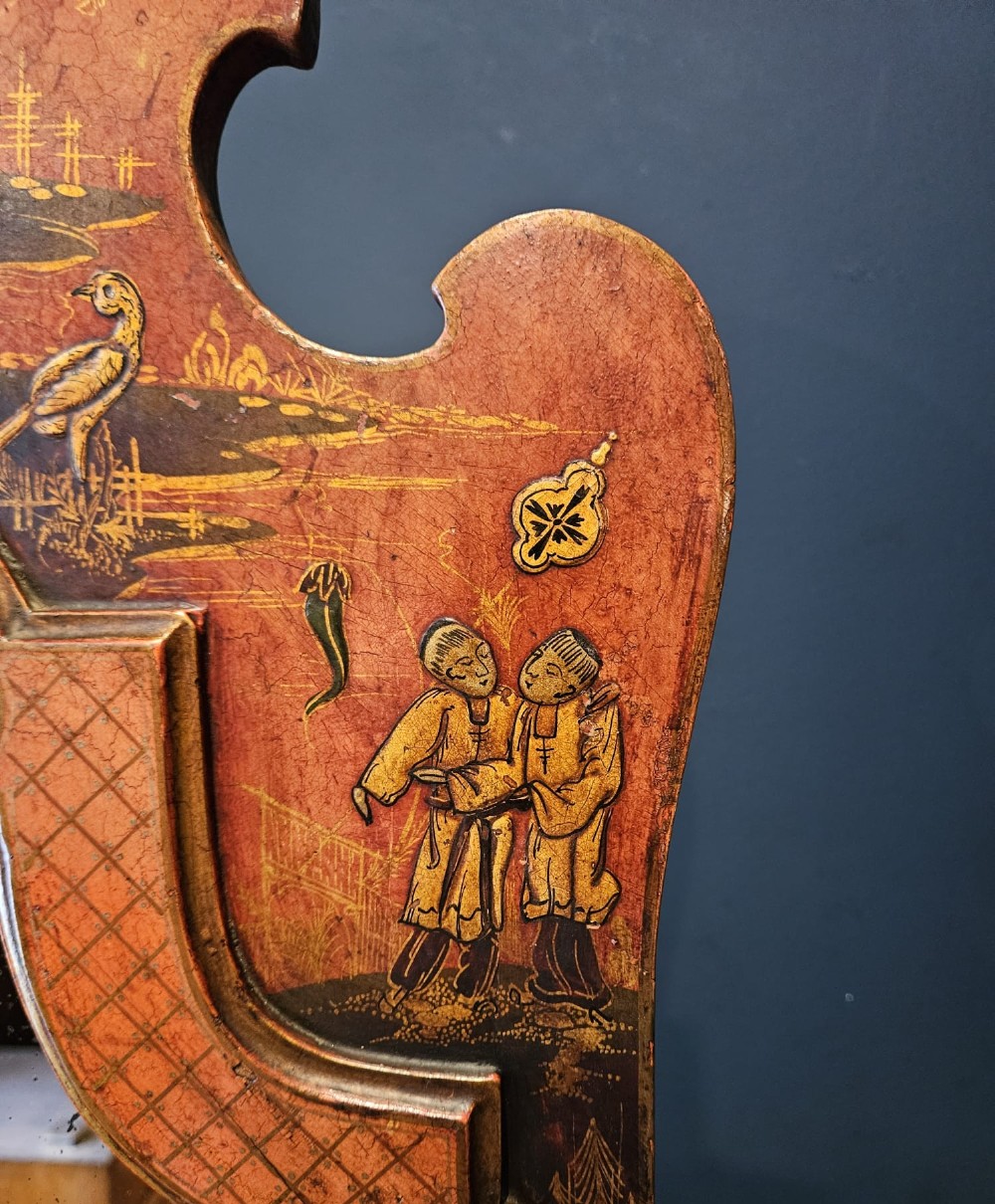 A tall 1920s Chinoiserie freestanding cheval mirror featuring an arched frame decorated with gold hand-painted Asian figures and landscapes on a warm terracotta lacquered background. View VIII