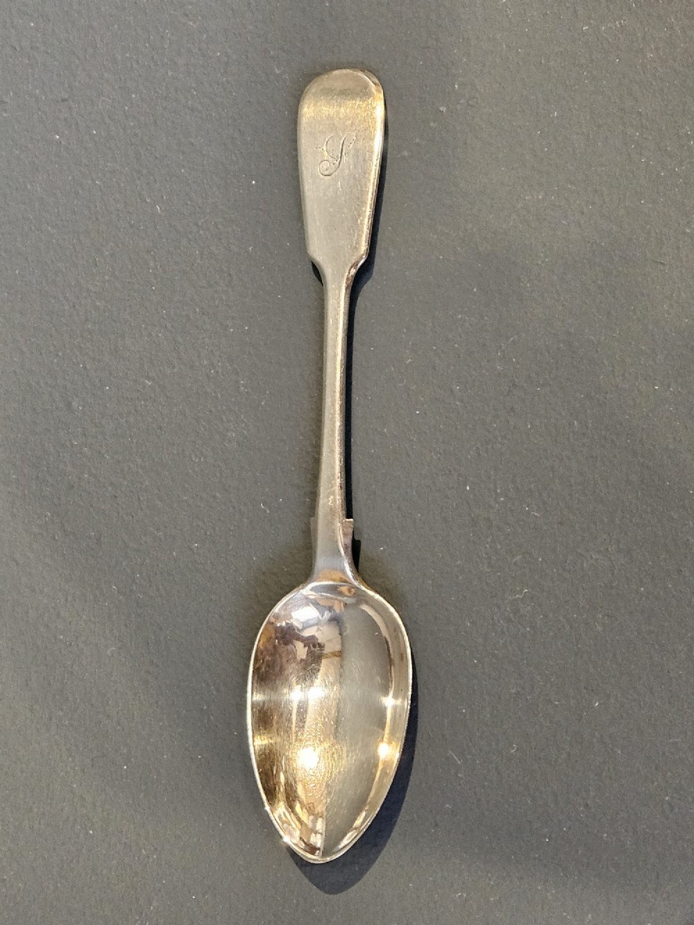 A set of six Victorian sterling silver teaspoons featuring engraved monograms on the handles. View II