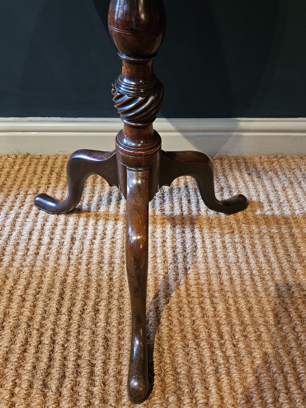 A George III mahogany snap top tripod table featuring a circular dished top, turned column with spiral detailing, and splayed cabriole legs. View VI