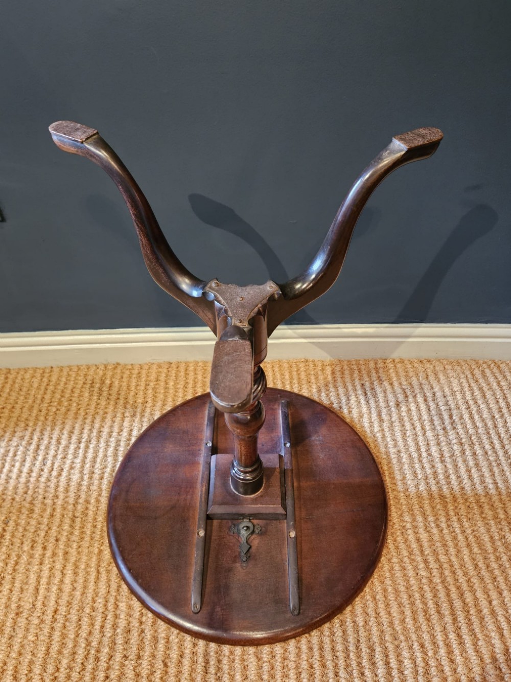A George III mahogany snap top tripod table featuring a circular dished top, turned column with spiral detailing, and splayed cabriole legs. View IX