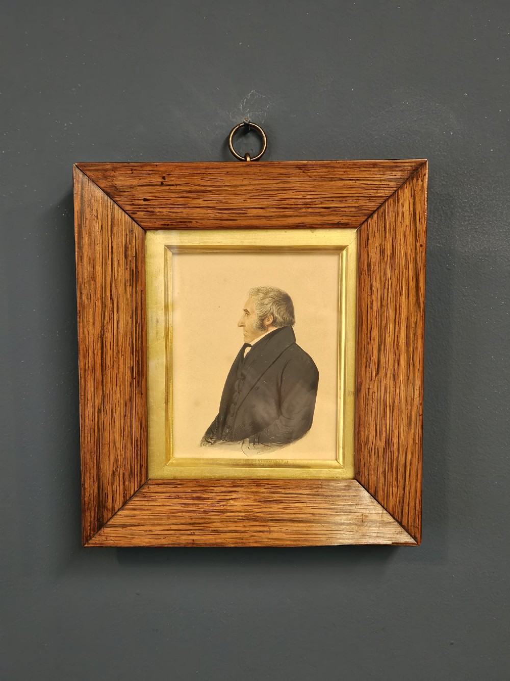 A pair of early Victorian profile portrait miniatures depicting a gentleman and a lady, presented in matching rosewood frames with gilt slips and brass hanging rings. View VI