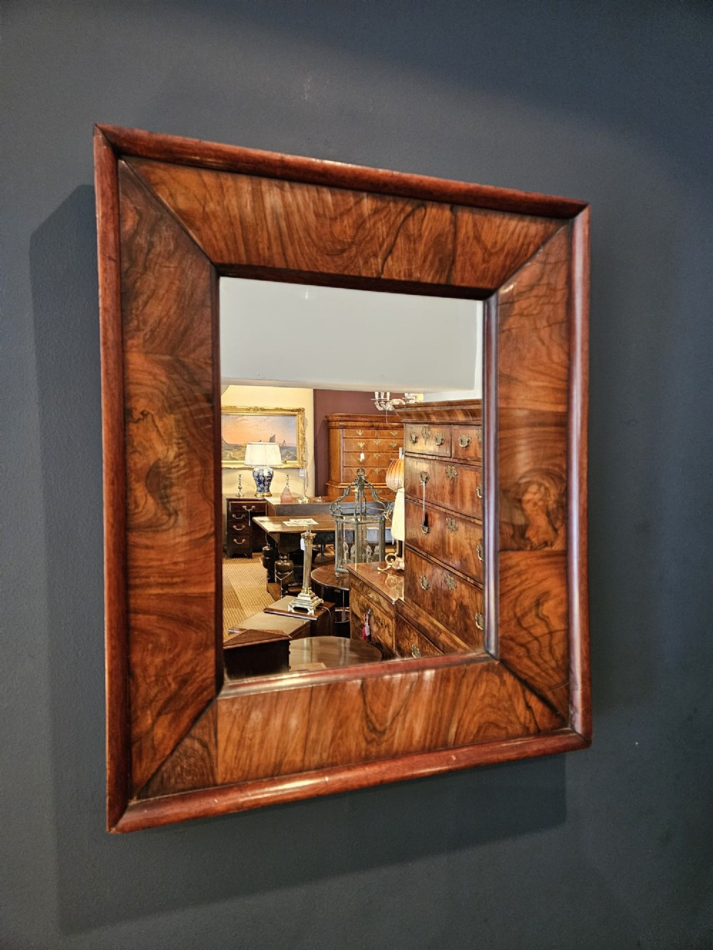 A rectangular wall mirror featuring a polished rosewood cushion frame with distinct wood grain patterns and mitred corner joints. View II