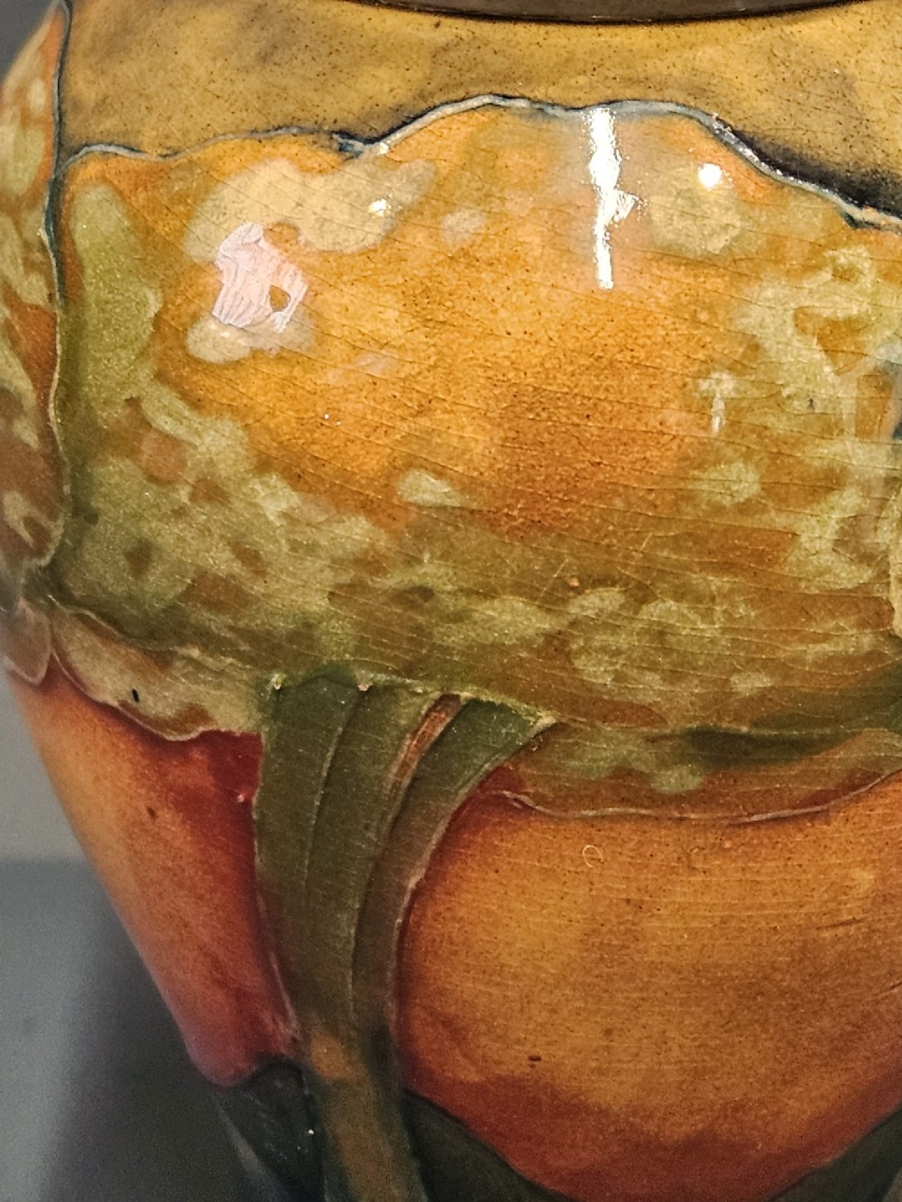 A Moorcroft Eventide glazed earthenware vase featuring a tubelined tree motif against an orange sky with a hammered pewter rim. View II
