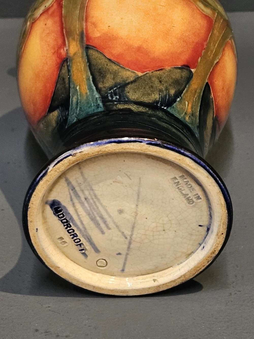 A Moorcroft Eventide glazed earthenware vase featuring a tubelined tree motif against an orange sky with a hammered pewter rim. View VI