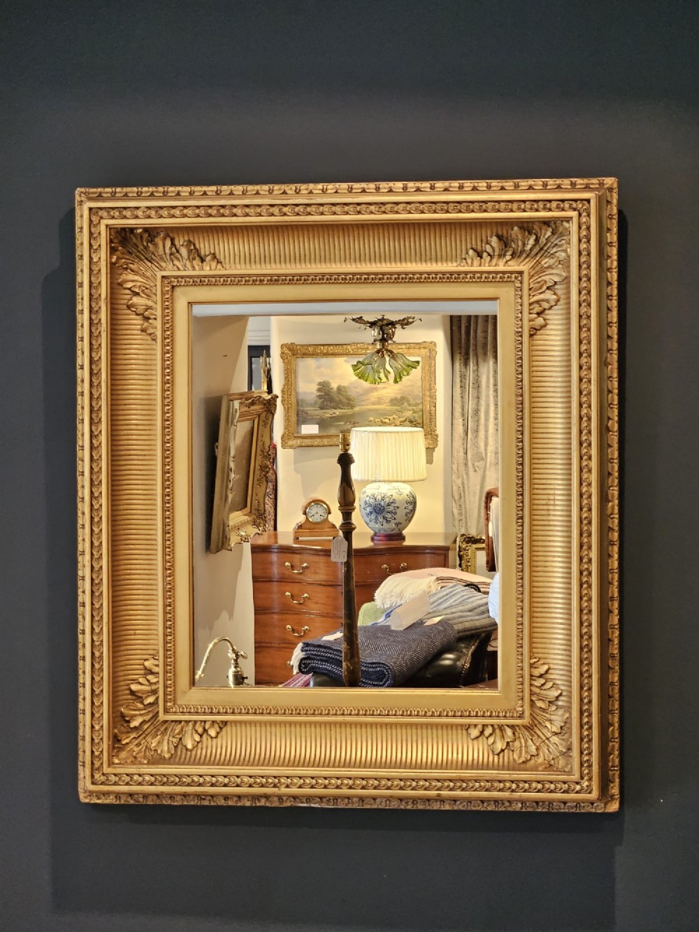 A rectangular Victorian giltwood wall mirror featuring fluted cove moulding, beaded inner borders, and raised acanthus leaf ornamentation at each corner. View III